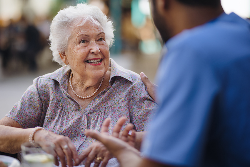 Woman smiling during a hair wash at a salon.